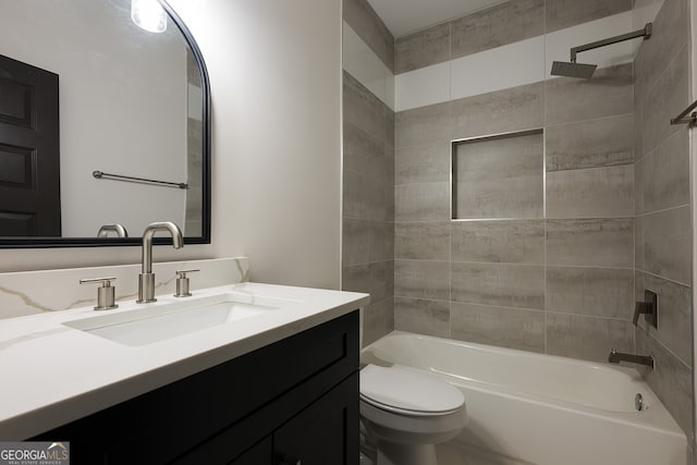 full bathroom with vanity, toilet, and tiled shower / bath