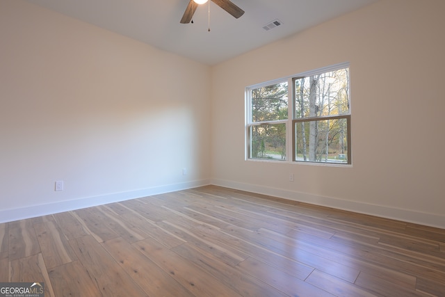 unfurnished room featuring hardwood / wood-style floors and ceiling fan