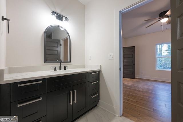 bathroom with hardwood / wood-style floors, vanity, and ceiling fan