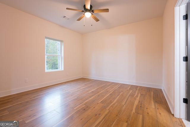 empty room with ceiling fan and light hardwood / wood-style floors