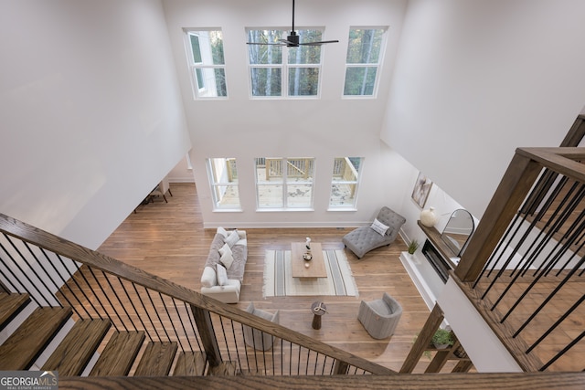 unfurnished living room featuring ceiling fan and light hardwood / wood-style flooring