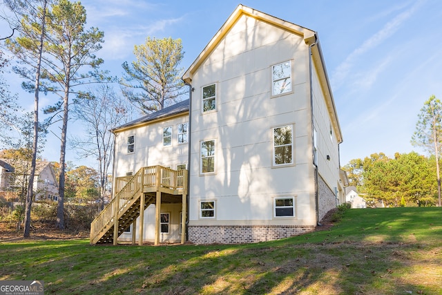 back of house with a lawn and a deck