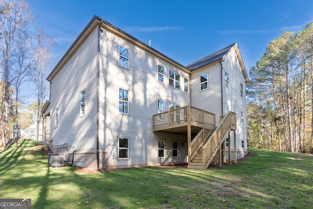 rear view of property with a yard and a wooden deck