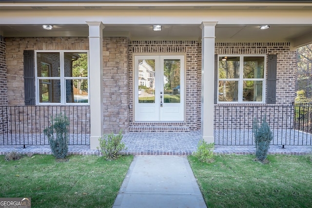 property entrance with a porch and french doors