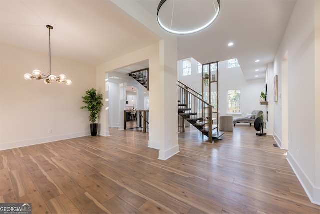 entryway featuring hardwood / wood-style floors and a notable chandelier