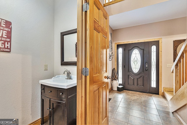 entrance foyer featuring light tile patterned flooring and sink