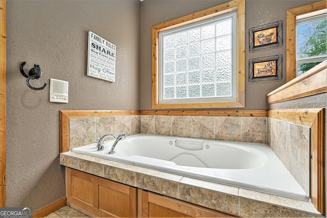 bathroom with a relaxing tiled tub