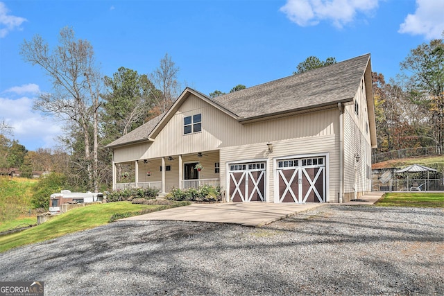 view of front facade featuring a porch and a garage