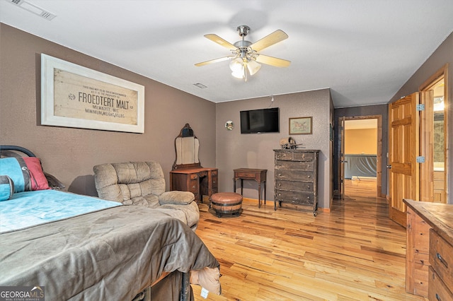 bedroom with light hardwood / wood-style flooring and ceiling fan