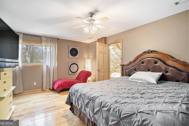 bedroom with ceiling fan and light hardwood / wood-style floors