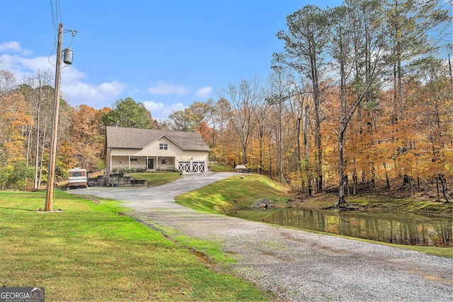 view of front of house featuring a front yard and a water view