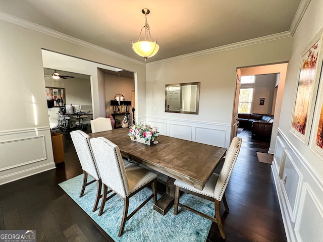 dining room with ceiling fan, dark hardwood / wood-style floors, and ornamental molding