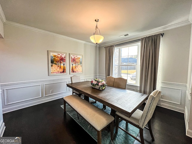 dining room featuring dark hardwood / wood-style floors and ornamental molding