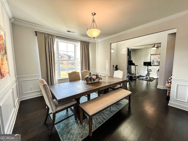 dining room with ceiling fan, dark hardwood / wood-style flooring, and ornamental molding