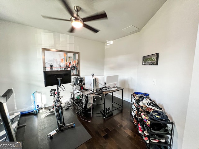 workout room featuring ceiling fan and dark hardwood / wood-style flooring