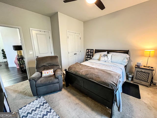 carpeted bedroom with ceiling fan and a closet