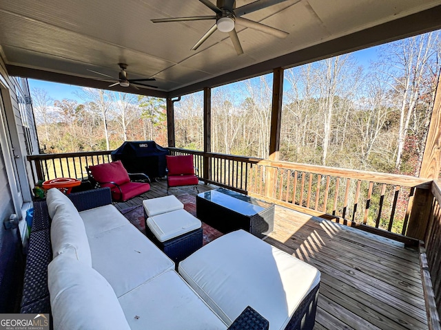 wooden terrace with outdoor lounge area, ceiling fan, and a grill