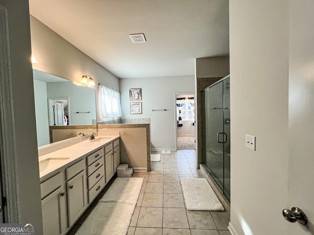 bathroom featuring tile patterned flooring, vanity, and an enclosed shower