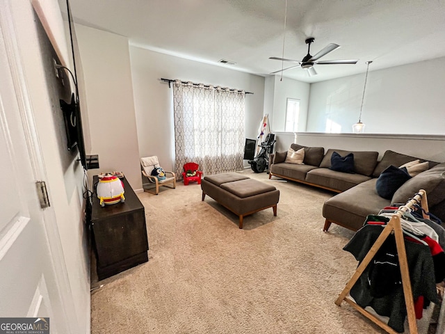 living room with ceiling fan and carpet floors