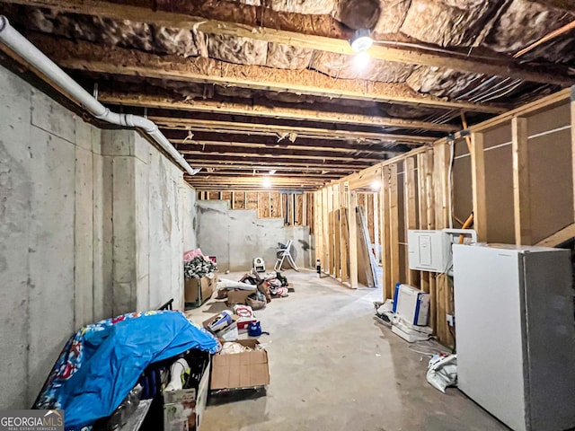 basement with white refrigerator