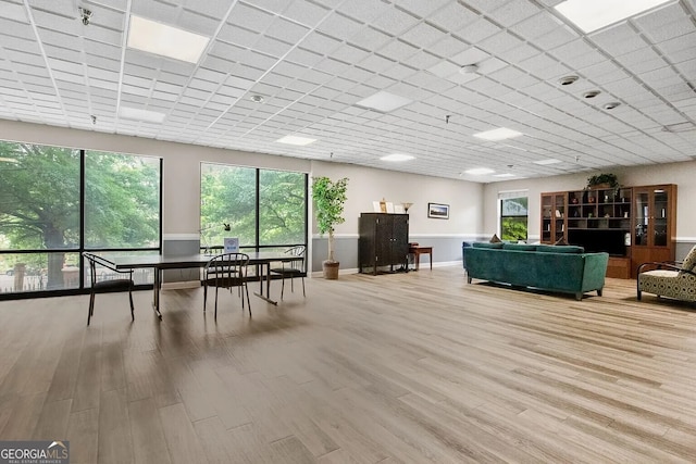 interior space with a paneled ceiling and wood-type flooring