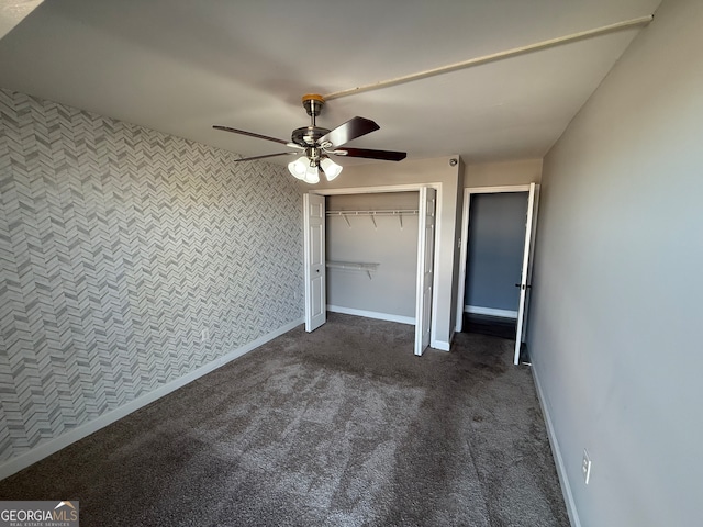 unfurnished bedroom featuring a closet, dark carpet, and ceiling fan