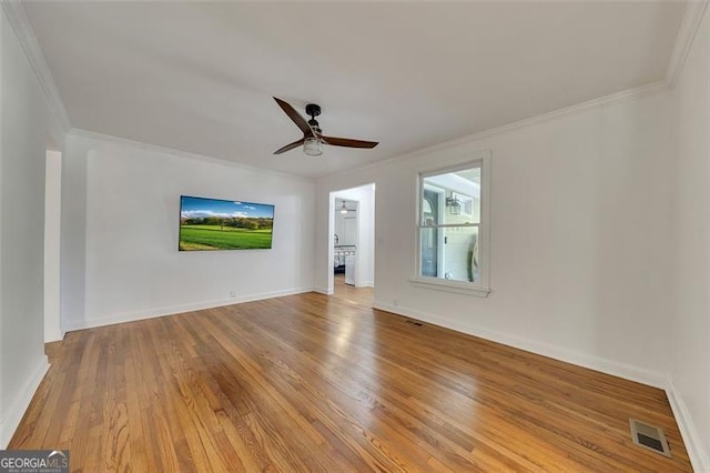 empty room featuring ceiling fan, light hardwood / wood-style flooring, and ornamental molding