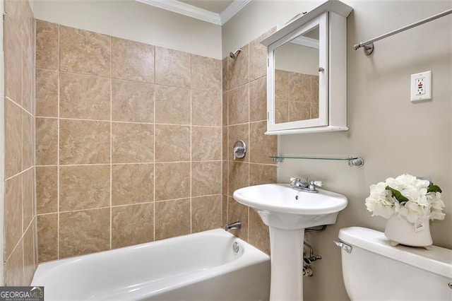 bathroom with tiled shower / bath, ornamental molding, and toilet