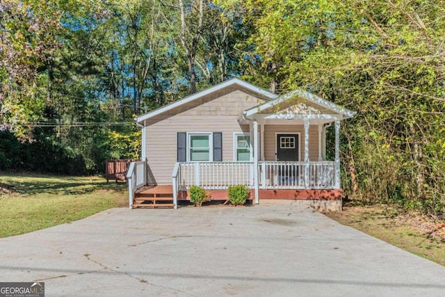 bungalow-style house with a porch and a front yard