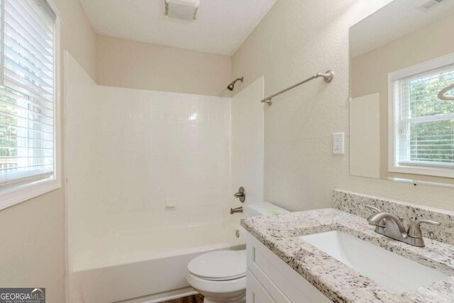 full bathroom featuring vanity, toilet, and tub / shower combination