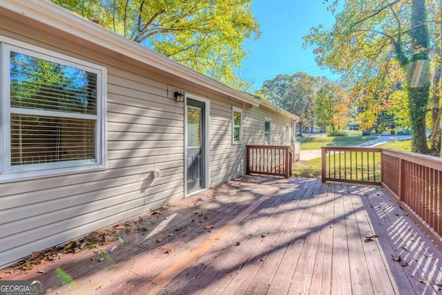 wooden deck featuring a yard