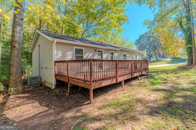 back of house with a deck and central AC unit