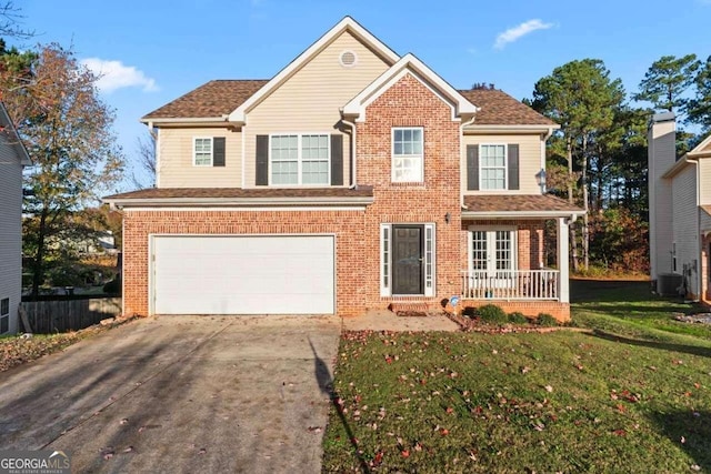 view of front of property with a front yard and a garage