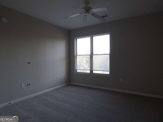 carpeted empty room featuring ceiling fan