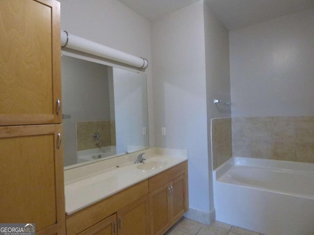 bathroom featuring tile patterned floors, a bathing tub, and vanity