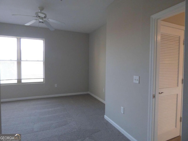 unfurnished room featuring ceiling fan and carpet floors