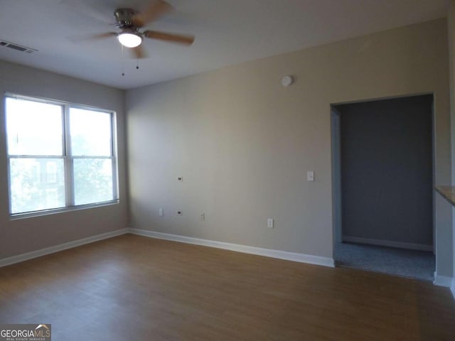 empty room featuring hardwood / wood-style floors and ceiling fan