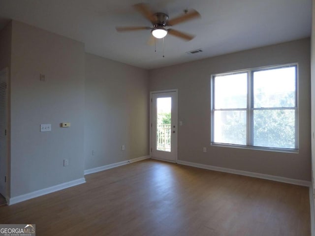 unfurnished room with ceiling fan and hardwood / wood-style flooring