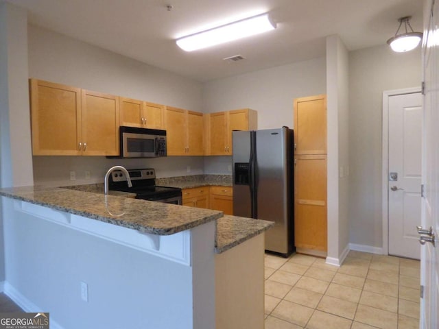 kitchen featuring kitchen peninsula, stainless steel appliances, light tile patterned floors, light brown cabinets, and dark stone countertops