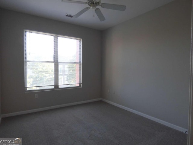 carpeted spare room with ceiling fan