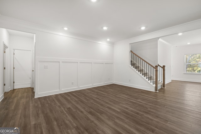 empty room featuring dark wood-type flooring and ornamental molding