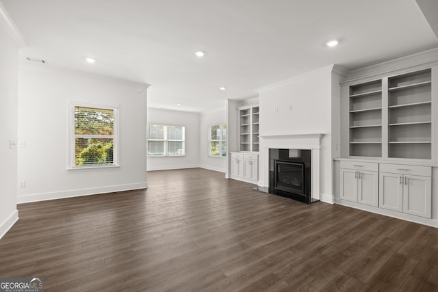 unfurnished living room with dark hardwood / wood-style floors and crown molding