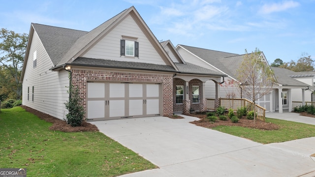 view of front of home with a garage and a front lawn