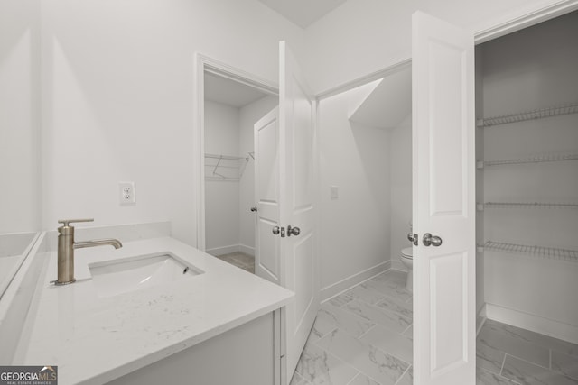 bathroom with vanity and toilet