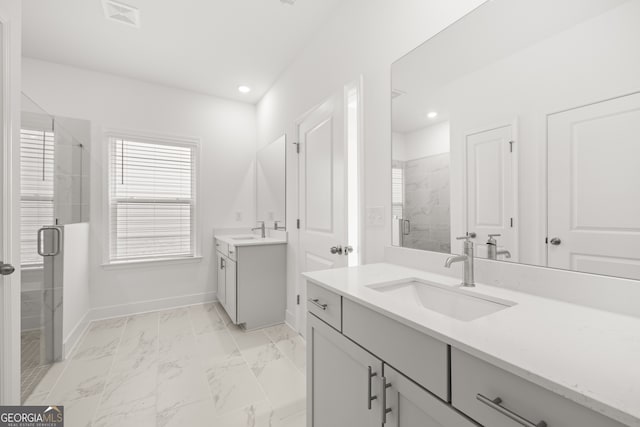 bathroom featuring vanity and an enclosed shower