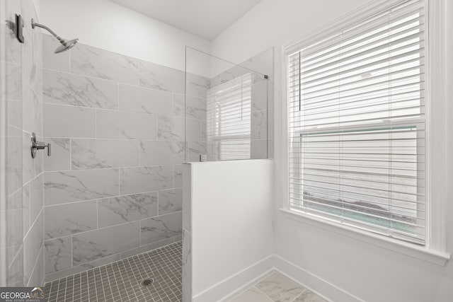 bathroom featuring a tile shower