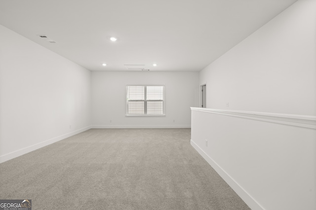 empty room featuring light carpet