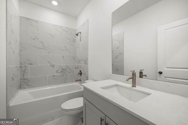 full bathroom featuring vanity, toilet, and tiled shower / bath combo