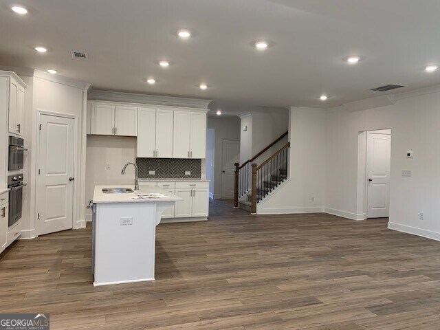 hallway featuring french doors, dark hardwood / wood-style flooring, and crown molding