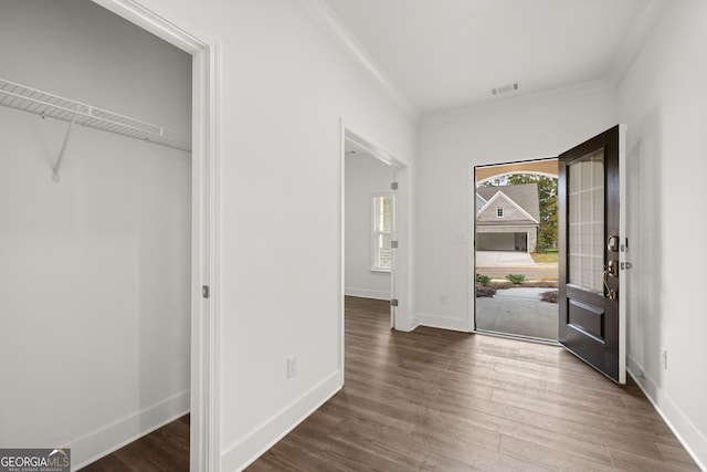 foyer entrance with crown molding and dark hardwood / wood-style floors